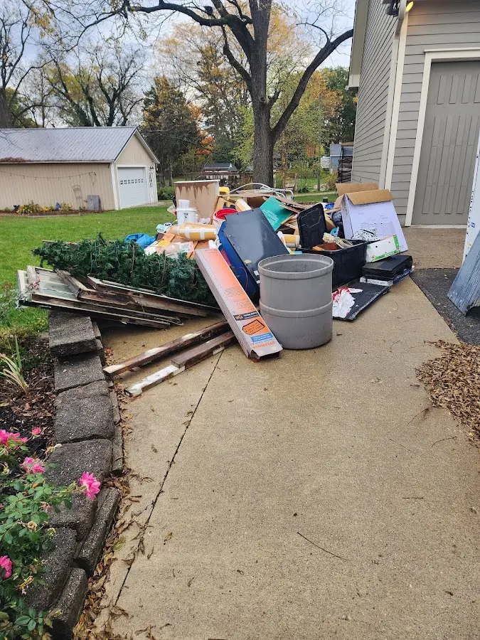 Dumpster being loaded with debris for Estate Cleanout Dumpster Rental in Belle Glade